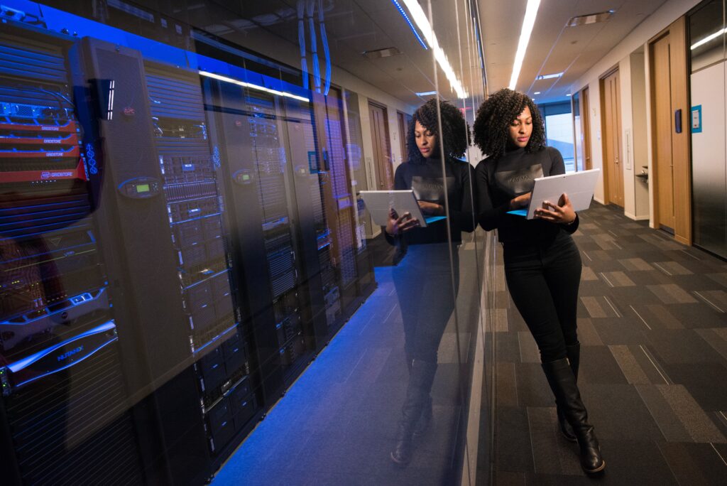 Woman leaning against server room