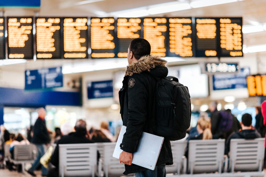 Man looking at information boards in airport