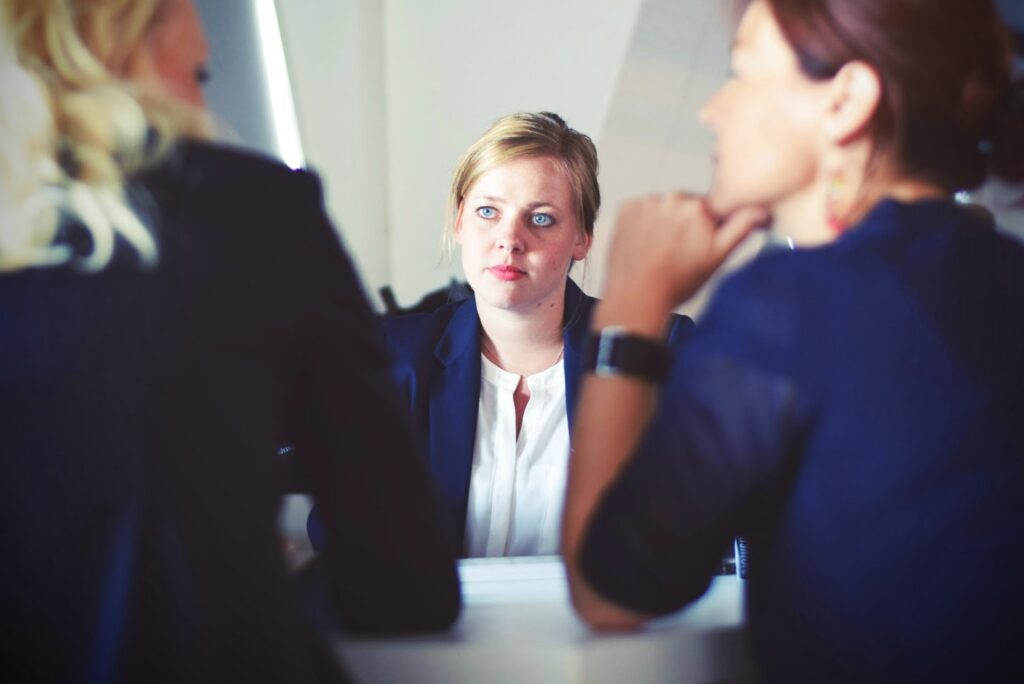 3 ladies sitting around a desk during a redundancy