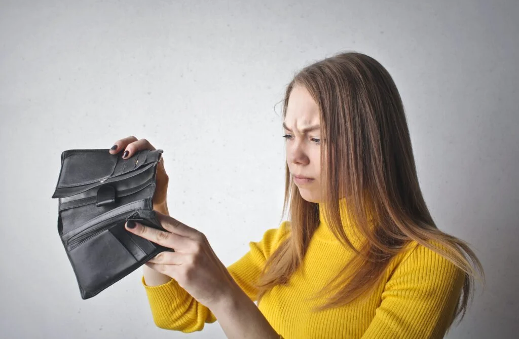 Lady looking into empty purse