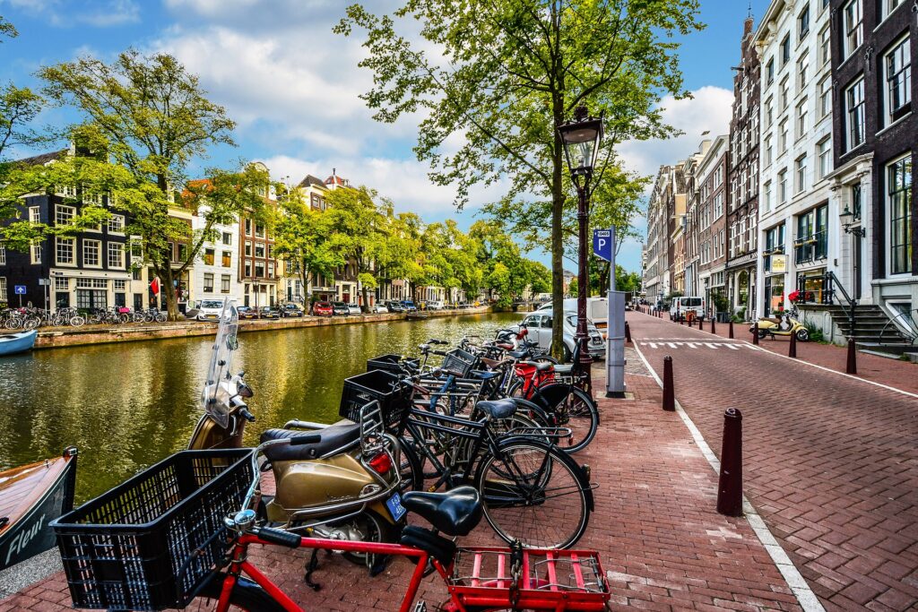 Amsterdam street view along canal with parked bicycles