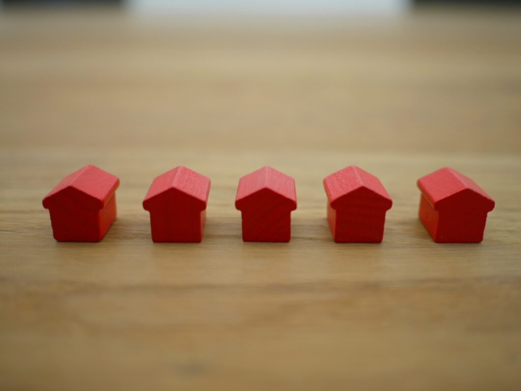 Row of red, wooden models of houses