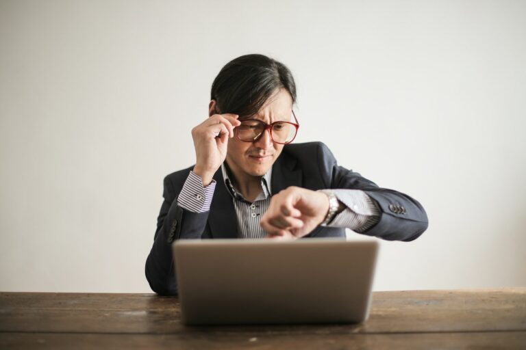 Businessman checking time on watch