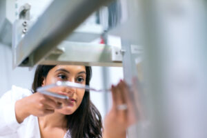 Female engineer working with equipment