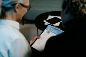 Two women looking at a candidate's resume.