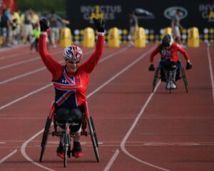 British paralympic wheelchair racer celebrating.