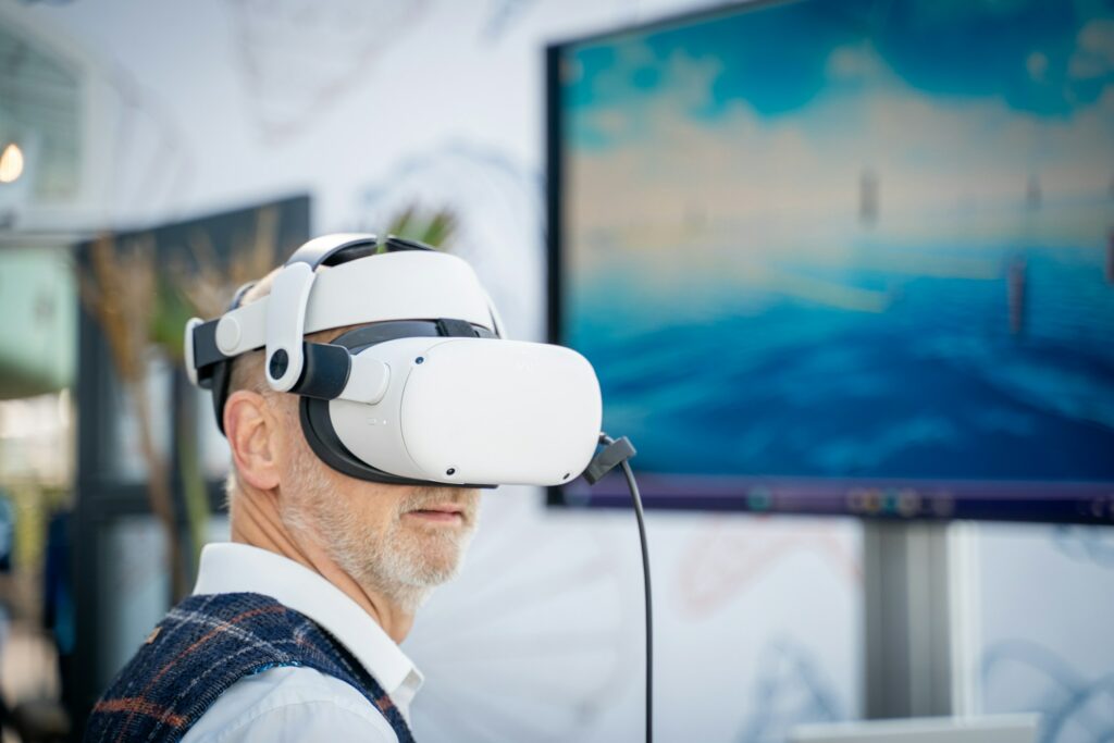 A man wearing a virtual reality headset, seemingly immersed in a VR experience.